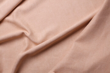 Fototapeta premium Beige microvelour texture. Fabric wavy background