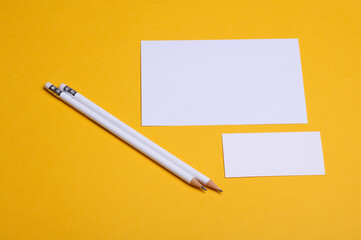 White blank cards with pencils on yellow background