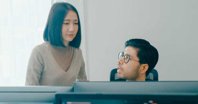 Group Adult Asia male, female freelance meeting write prompt AI bot IT app smart program nomad, video game, talk strategy, discuss plan, user interface, designer, big data center on desktop computer.