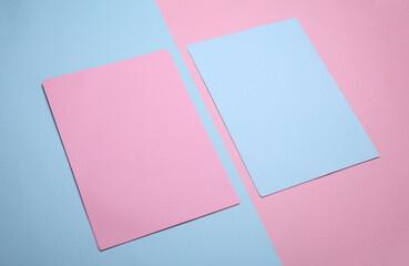 Blue and pink sheets of paper of A4 size on pastel background