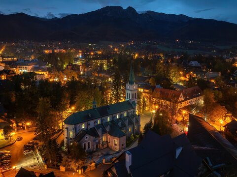 Zakopane: Widok na miasto rozświetlone lampami o poranku, jesienią z drona