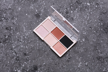 Makeup eyeshadow palette on concrete background