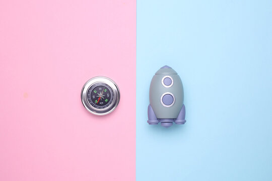 Pear-shaped space shuttle and compass on blue pink background. Startup idea