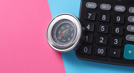 Notepad with compass on pink blue background. Business concept
