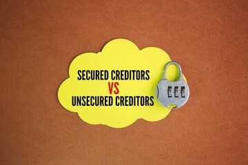 key and paper with the words secured vs unsecured creditors. Secured creditors are first in the...