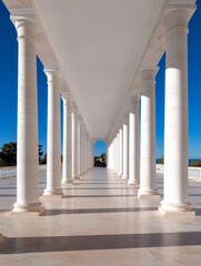 Fototapeta premium Contemporary Neo-Classical Architecture Sunlit Marble Corridor with Pillars - Premium Design Content for Sustainable Real Estate and Elegant Urban Planning