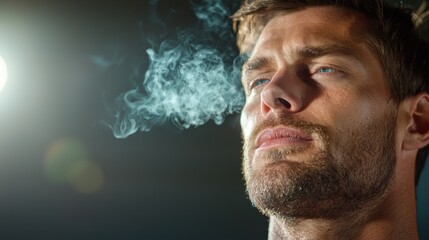 Portrait of a pensive contemplative man exhaling smoke in a dimly lit room creating a moody atmospheric and dramatic scene  The image evokes feelings of introspection solitude