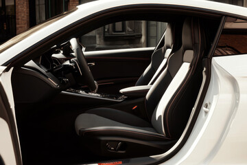 Luxury car interior featuring modern design and premium materials in an urban setting during daylight