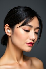 Obraz premium Woman Wearing Wireless Earbuds Closeup Studio Shot
