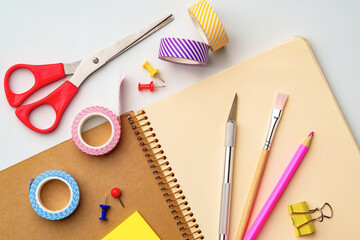 Crafting tools and supplies arranged on a workspace for creative projects and organization