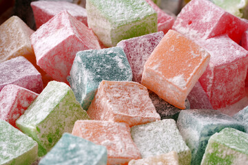 Colorful assortment of sugary confectionery displayed in a market setting during daytime
