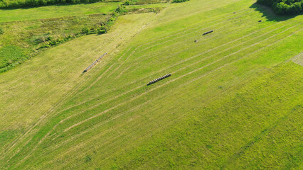 Obraz premium Harvested fields with hay bales in rows