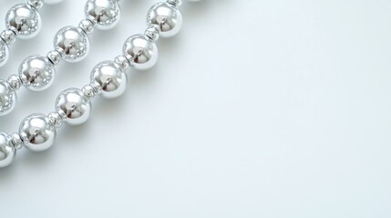 Obraz premium Silver beads border, white background, holiday decor, craft