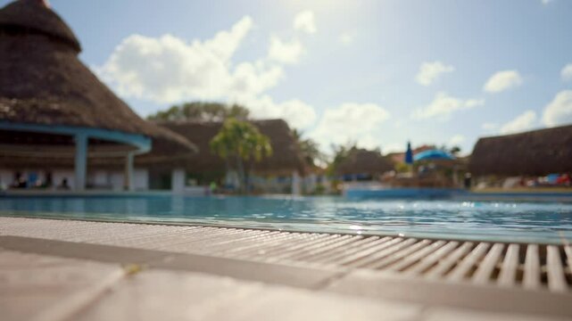 Relax time in luxury hotel with swimming pool in summer sunny day, static shot. Traveling and tourism in summer vacation, enjoy freedom and relaxation, bright sunshine and warm blue water in pool