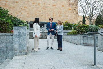 Businesspeople talking outside office building during break