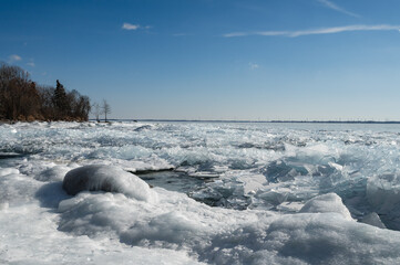 Ice formations on shore of Lake Ontario, Canada on winter day.