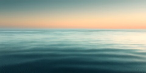 Fototapeta premium A serene seascape at dawn, with calm turquoise waters reflecting soft pastel hues of the sky, creating a tranquil and peaceful mood.