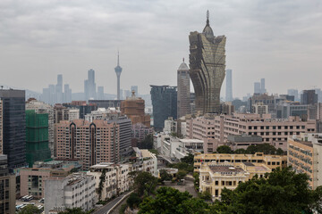 Fototapeta premium Iconic Grand Lisboa building under cloudy skies in Macau