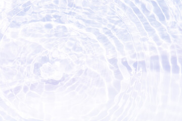 White water with ripples on the surface. Defocus blurred transparent white colored clear calm water surface texture with splashes and bubbles. Water waves with shining pattern texture background.