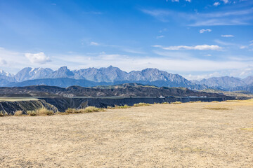 Gravel dirt square and grand canyon with mountains on a cloudy day
