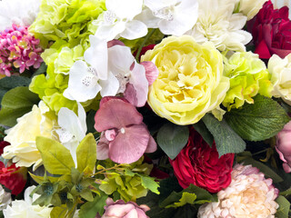 A bouquet of flowers with a mix of pink, white, and yellow flowers
