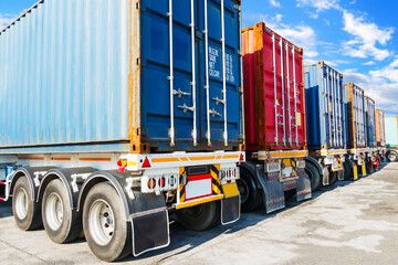 Naklejka premium Semi Trailer Trucks on The Parking Lot. Shipping Cargo Container. Handling of Logistics Transportation Industry. Freight Truck Import-Export. Logistics Truck Transportation 