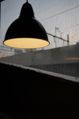 chandelier in a hotel room with a background of foggy glass and train tracks on the streets of...