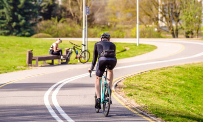 Cyclist ride on the bike path in the city Park