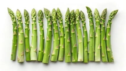 Fototapeta premium A symmetrical row of fresh green asparagus spears carefully arranged on a clean white background. A simple and elegant food composition.