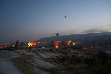 Beautiful view of hot air balloon flying over rock landscape at Cappadocia Turkey