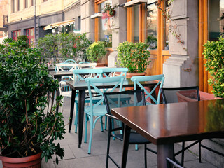 Empty tables at a street cafe in the historic part of the city.