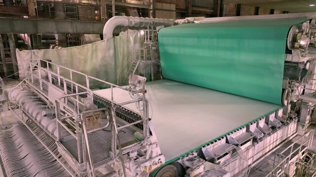 A paper machine for the production of white paper. Shafts with paper pulp.