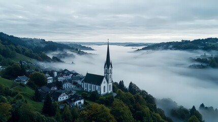 Fototapeta premium Misty morning landscape of rolling hills with church aerial view countryside tranquil atmosphere