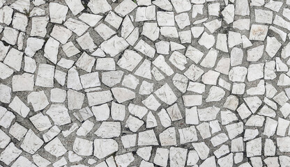 texture of light mosaic stones on the pavement, top view