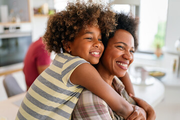 African american woman hugging her smiling teen daughter. Family love single parent child concept