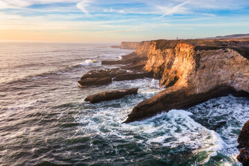 Aerial view of beautiful sandy beach and cliffs of Pacific Ocean coast on Highway 1 in California, Davenport, Santa Cruz. Travel concept, tourism, recreation, vacation