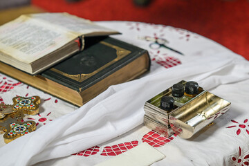 Accessories of a priest for Christian baptism. The text in the book is in Serbian