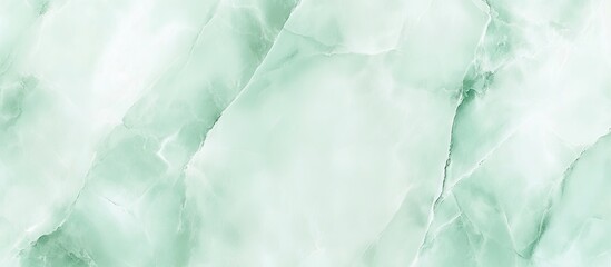 Fototapeta premium Pastel mint marble texture with soft green hues and subtle white veining, ideal for elegant backgrounds and product design applications.