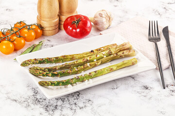 Grilled asparagus sprouts served red pepper