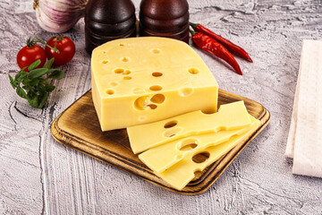Maasdam cheese piece with slices