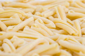 casareccia, close up of a pile of italian pasta on a white background