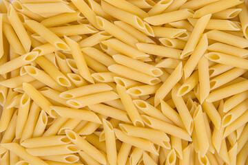Raw penne pasta background. Top view. Close-up.