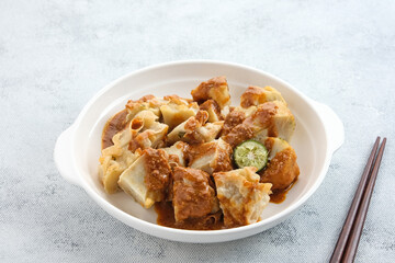 Batagor, made from fish or chicken dumpling, tofu, tapioca flour served with peanut sauce. Indonesian food
