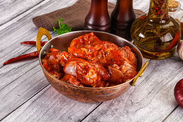 Raw marinated buffalo chicken wings