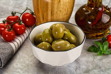 Big green marinated olives in the bowl