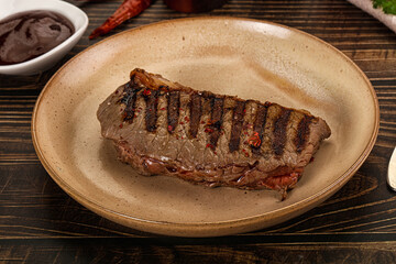 Grilled beef striploin steak with sauce