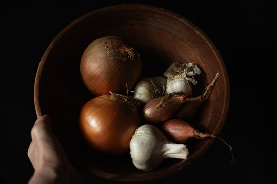 Wooden bowl of onion, garlic, shallots