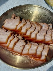 Suyuk, a traditional Korean dish of boiled pork slices, tender and juicy, often served with salted shrimp sauce, garlic, and ssamjang. Perfect for wrapping in lettuce for a flavorful, balanced bite.