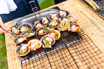 Grilling fresh scallops at outdoor wedding reception