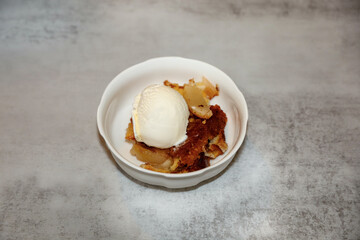 Pear cobbler with a scoop of vanilla ice cream on top.
